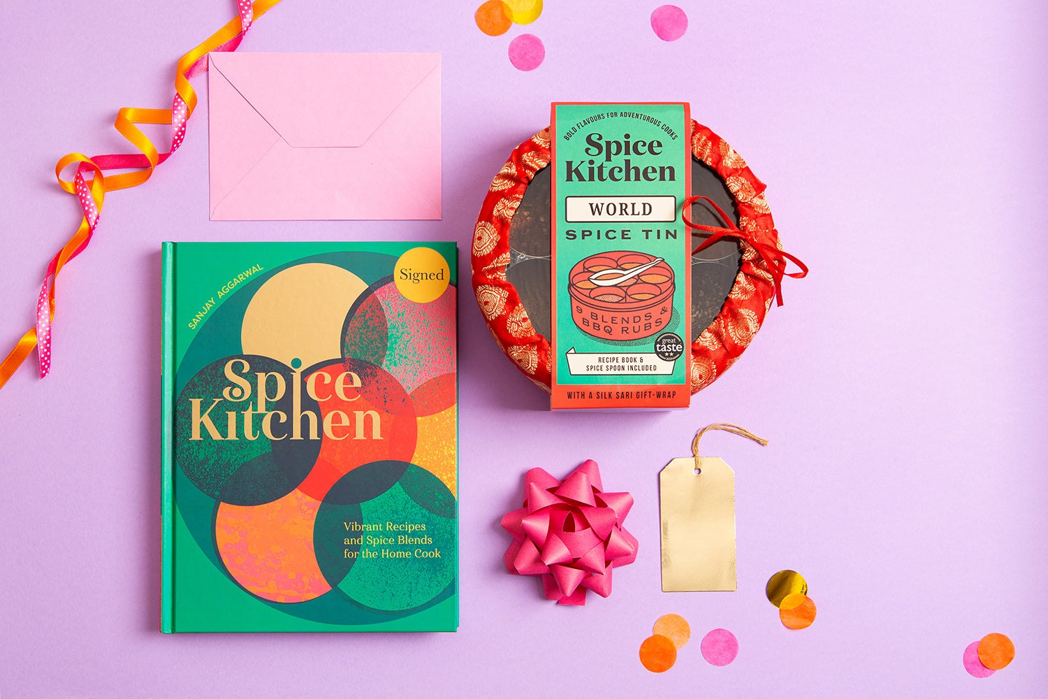 Spice Kitchen cookery book by Sanjay Aggarwal, and spice kit on a purple background with decorative elements