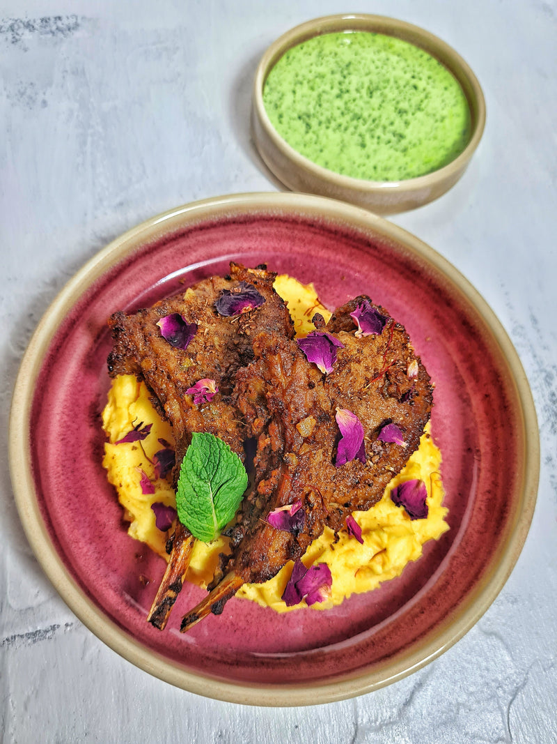 Gunpowder masala lamb chops with grilled lamb coated in a spicy South Indian spice mix, charred and garnished with herbs.