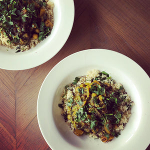 Vegetarian aubergine and squash tagine served on a bed of fluffy couscous, garnished with a handful of spinach and fresh coriander 