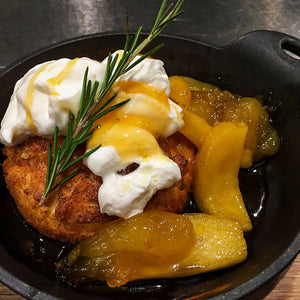 Spicy Cinnamon Apple Brown Butter Skillet Shortcakes served with a generous dollop of soured cream and a sprig of rosemary