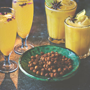 4 glasses of Sanjay's Festive Apricot and Harissa Bellini served with a small bowl of seasoned peanuts