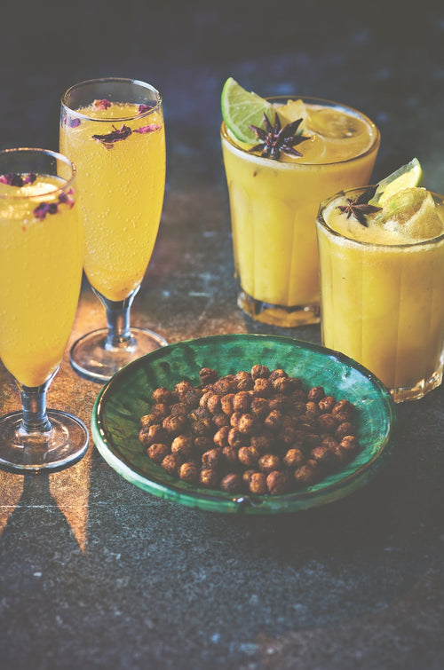 4 glasses of Sanjay's Festive Apricot and Harissa Bellini served with a small bowl of seasoned peanuts