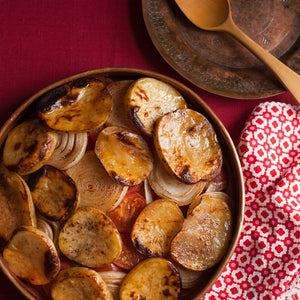 Baked kafta with roasted potatoes, onions, and tomatoes