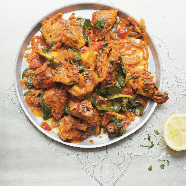 Tandoori Chicken with baby spinach leaves garnished with fresh coriander and a squeeze of lemon