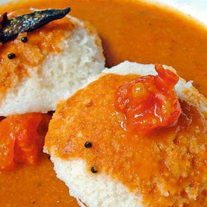 Traditional South Indian idli and sambar breakfast platter