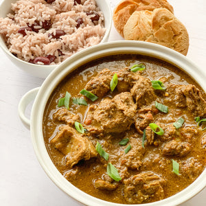 A big bowl of Jamacian Goat Curry with some rice and peas 
