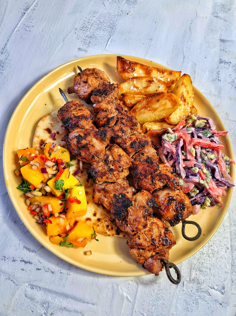 Jerk Chicken Skewers, Garlic & Thyme Potato Wedges, Blue Cheese Slaw, Mango, Chilli & Lime Salsa