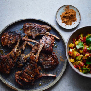 A plate of Succulent Jerk Lamb Chops served with a colourful Mango Salsa.