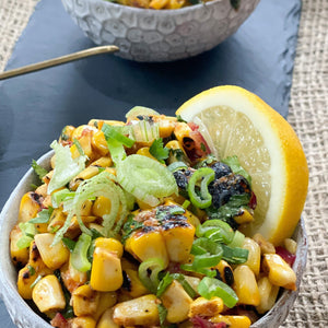 Two bowls of Masala Corn by chef Hey Renu. Served with a lemon wedge. 