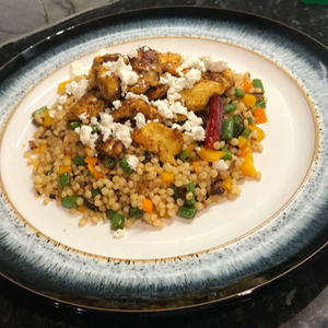 Neha D'Souza's moroccan chicken with pearl couscous, served with crumbled feta cheese on top 
