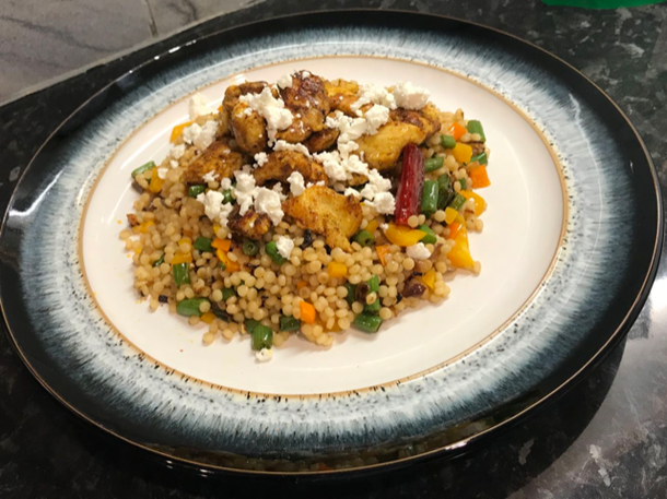 Neha D'Souza's moroccan chicken with pearl couscous, served with crumbled feta cheese on top 