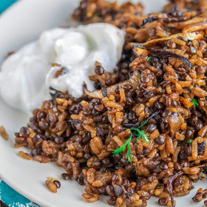 Lentil and rice dish topped with caramelized onions and yogurt