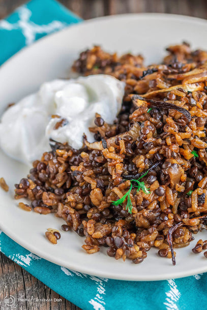 Lentil and rice dish topped with caramelized onions and yogurt