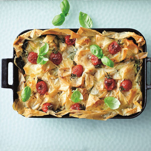 Garam Masala Bastilla topped with golden crispy filo pastry, cherry tomatoes and fresh basil leaves served in a rectangular baking dish
