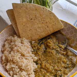 Vegan dhal made with red lentils, served with white rice and a chapatti