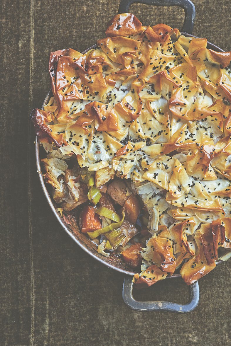 A beautiful crispy-looking Tandoori-Spiced Celeriac Butternut Squash Pie with one Portion spooned out of it.