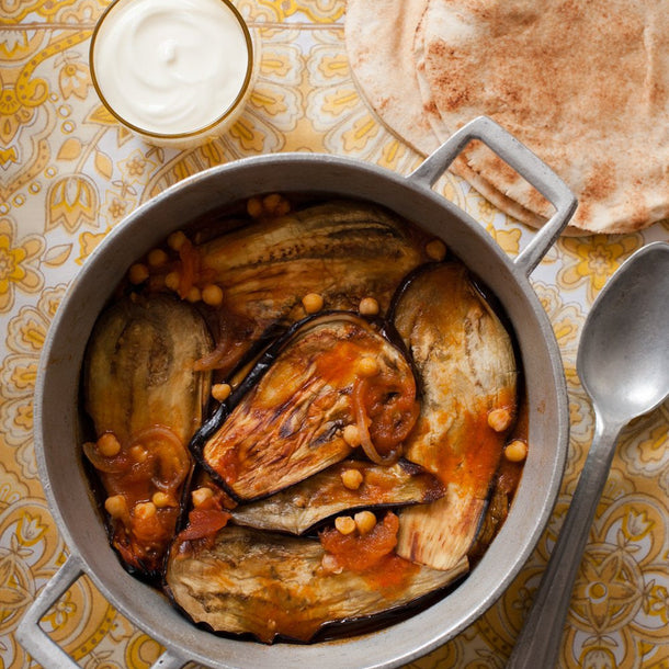Braised aubergine with chickpeas served with flatbread and yogurt