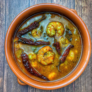 Chemmeen Ulli Theeyal with prawns simmered in a rich roasted coconut and tamarind gravy with onions and spices.