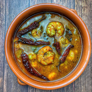Chemmeen Ulli Theeyal with prawns simmered in a rich roasted coconut and tamarind gravy with onions and spices.
