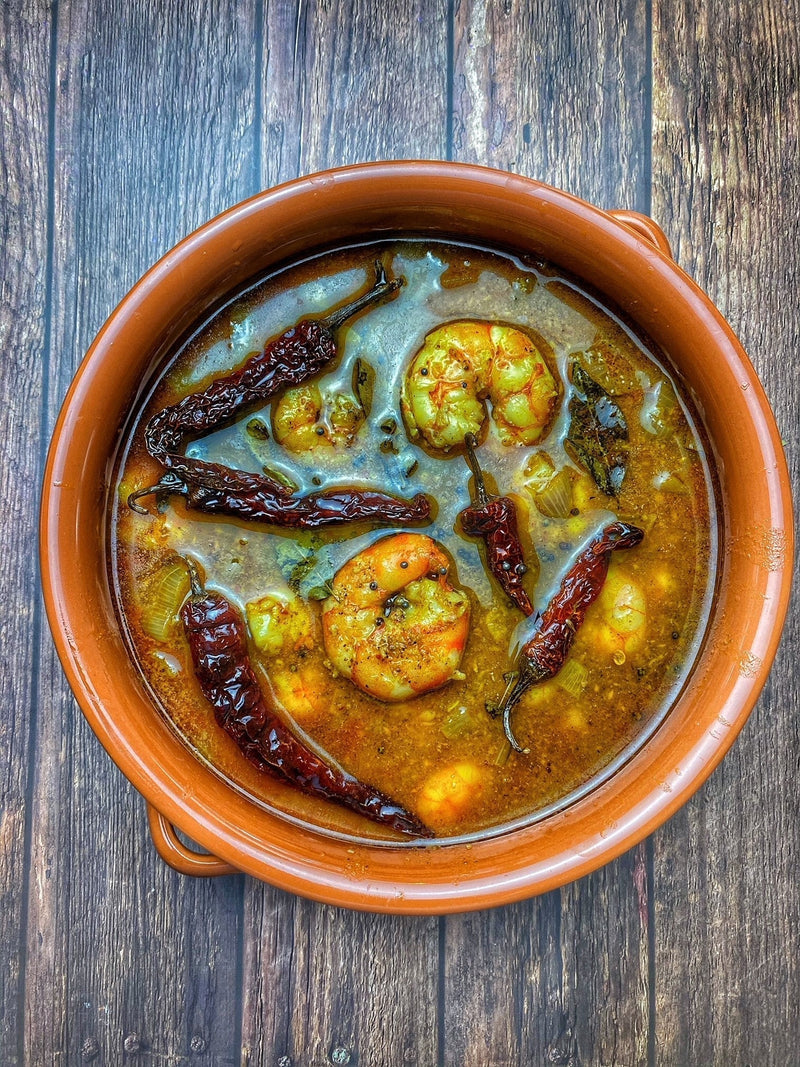 Chemmeen Ulli Theeyal with prawns simmered in a rich roasted coconut and tamarind gravy with onions and spices.