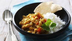 Chickpea curry served with white rice and crispy papadums