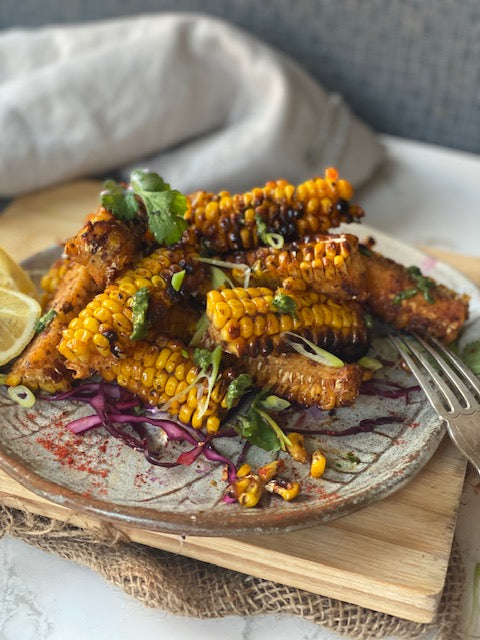 Corn ribs by Renu Bhardwaj featuring roasted corn cut into rib-like strips, seasoned with spices and lightly charred.