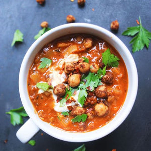 Tunisian harissa chickpea stew with chickpeas simmered in a spicy tomato broth, infused with harissa paste and herbs.