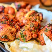 Spicy chicken kebabs with marinated chicken pieces grilled on skewers, lightly charred and coated in bold spices.