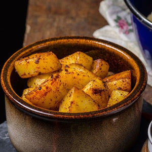 Crispy golden roast potatoes tossed with smoky Urfa chilli flakes, served hot with a crunchy exterior and fluffy centre.