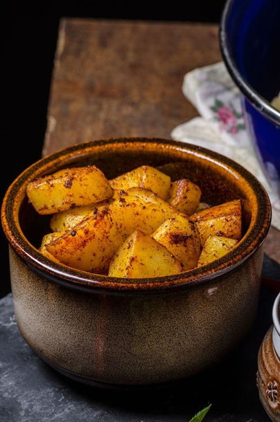 Crispy golden roast potatoes tossed with smoky Urfa chilli flakes, served hot with a crunchy exterior and fluffy centre.