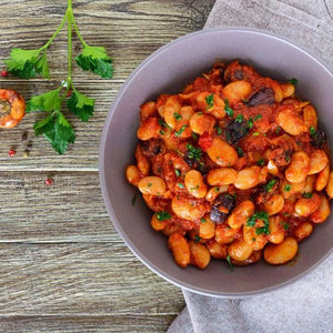Spanish bean stew with paprika featuring slow-cooked beans in a rich tomato broth with smoked paprika and herbs.