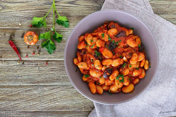 Spanish bean stew with paprika featuring slow-cooked beans in a rich tomato broth with smoked paprika and herbs.