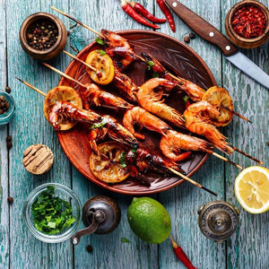 Grilled prawns with harissa, featuring juicy prawns lightly charred and coated in a spicy North African harissa glaze.
