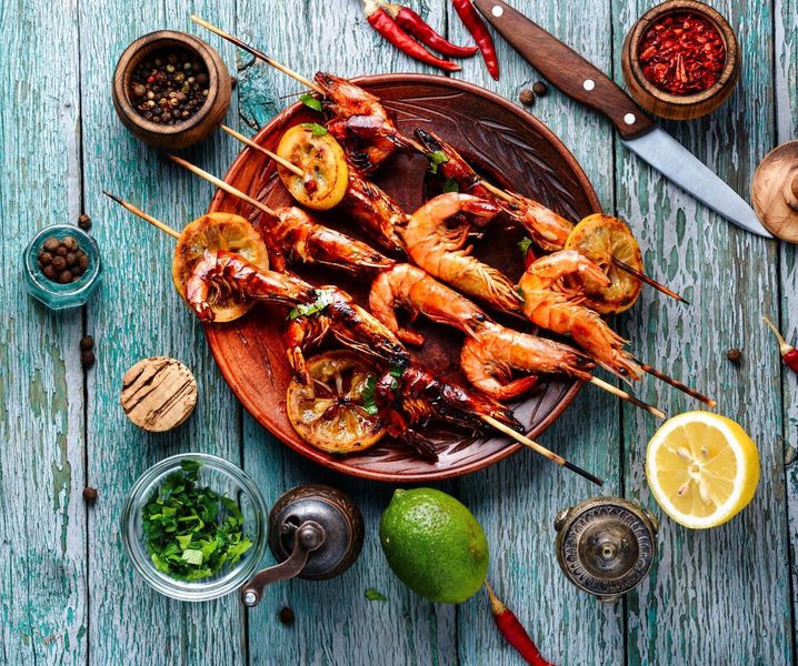 Grilled prawns with harissa, featuring juicy prawns lightly charred and coated in a spicy North African harissa glaze.