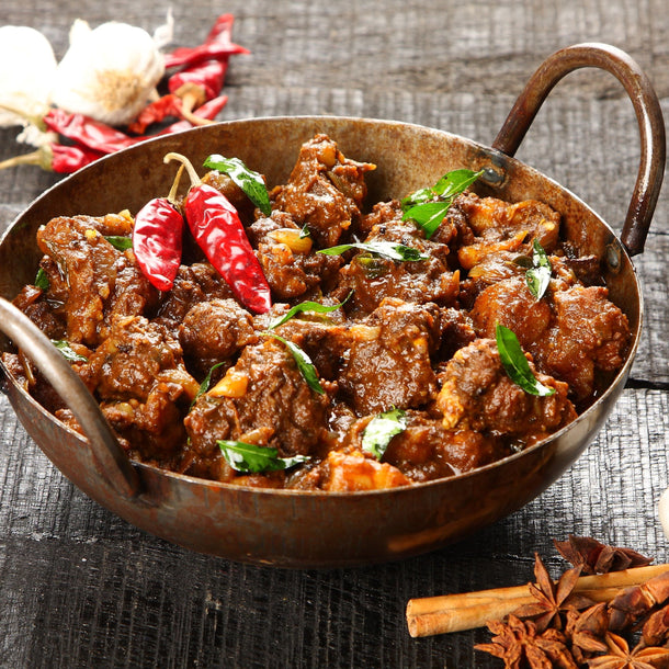 Kerala beef pepper fry with tender strips of beef cooked in black pepper, curry leaves, and spices, finished with a rich, glossy coating.