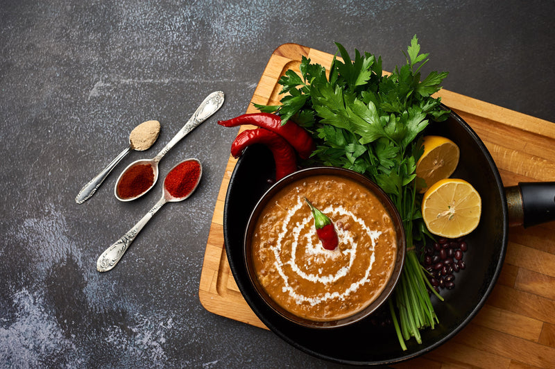 Dal makhani made with slow-cooked black lentils and kidney beans in a rich, creamy tomato-butter gravy, finished with herbs.  Excerpt: