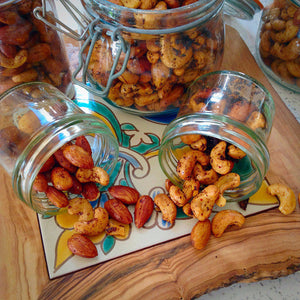 Jars of homemade spiced nuts with almonds and cashews