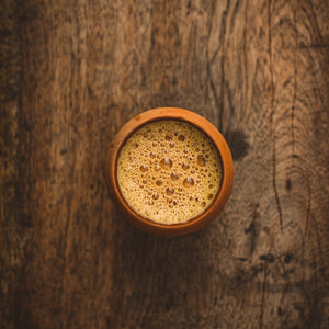 Traditional Indian chai served in a clay cup on wooden table
