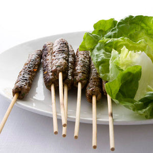 Spicy Middle Eastern kofte skewers served with lettuce and yogurt dip