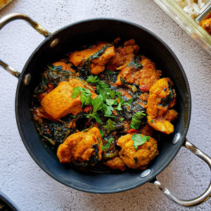 Quick chicken saag by MANI with tender chicken cooked in a spiced spinach (saag) sauce, finished with herbs.