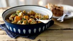 Bowl of homemade turkey curry with vegetables and herbs