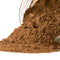 Close-up of ground Spice Kitchen allspice spilling from a jar onto a white background