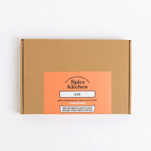 A square brown kraft cardboard box with a peach-orange front label reading 'Spice Kitchen' and 'GIN', photographed on a clean white background.
