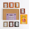 Spice Collection Middle Eastern spice kit on a white background, including a brown kraft box with a purple label, a yellow-orange recipe book, and seven spice pouches arranged around it.