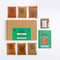 Spice Kitchen World spice collection set on a white background, featuring a brown cardboard box with a green label, seven small spice pouches and a green recipe guide booklet.