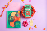 Spice Kitchen cookery book by Sanjay Aggarwal, and spice kit on a purple background with decorative elements