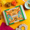 Spice Kitchen Indian Banquet feasting kit on a yellow background with decorative elements.