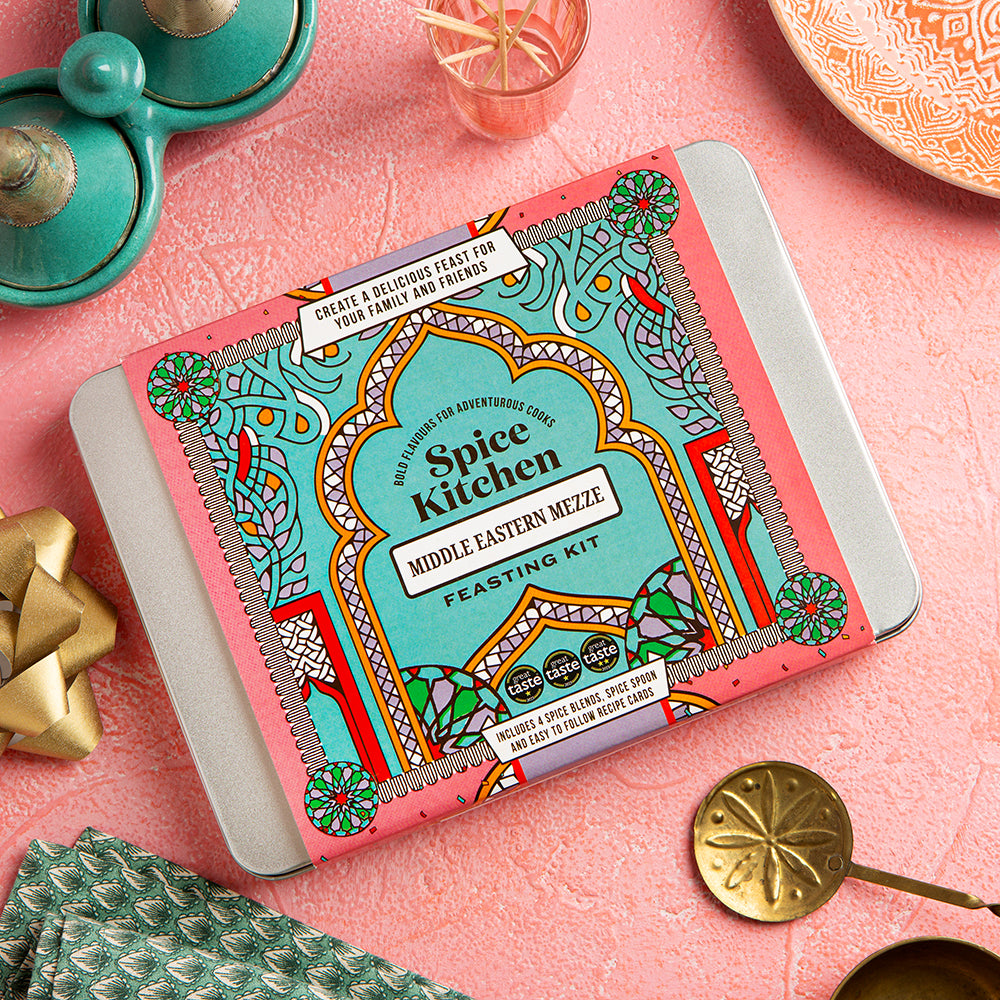 Spice Kitchen Middle Eastern Mezze Feasting Kit on a pink surface with decorative elements.