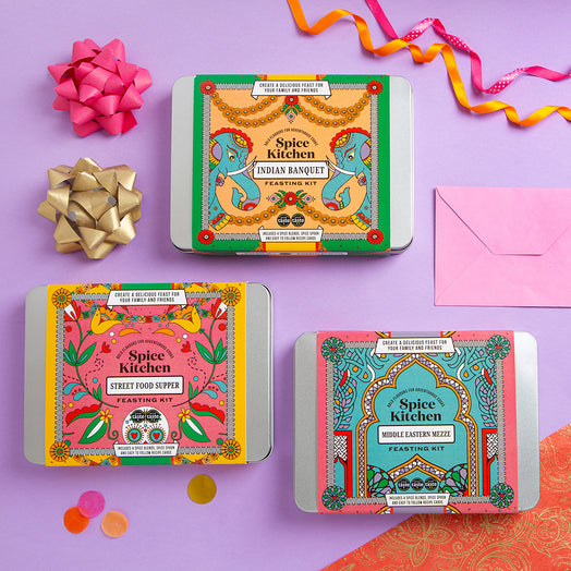 Three Spice Kitchen feasting kits on a purple background with ribbons and an envelope for gifting