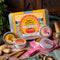 Spice Kitchen's Feasting Tin – A Story of Spice' with four signature spice blends on a wooden chopping board with spices and silk sari material. 